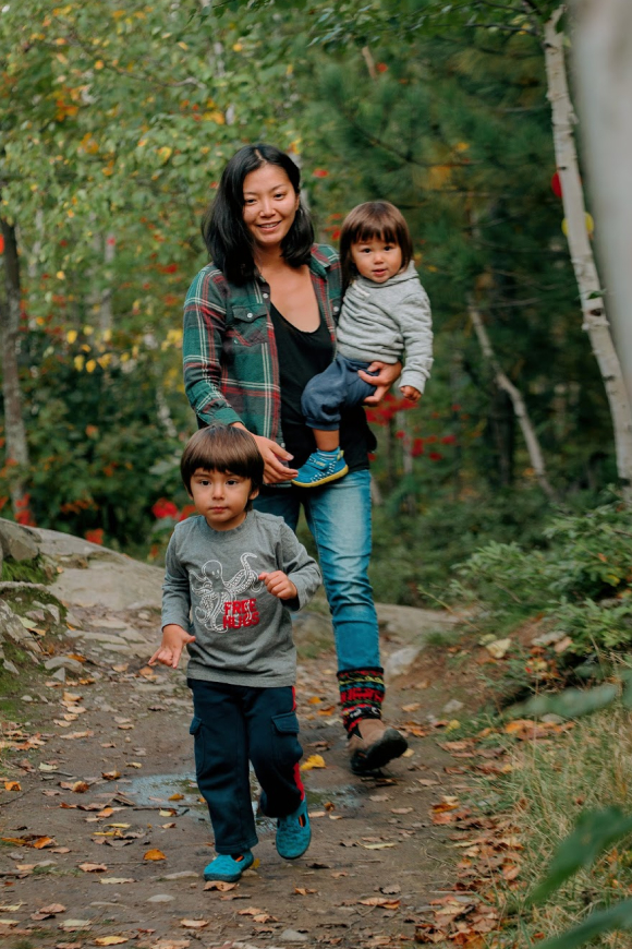 Mother walking on trail with 2 children