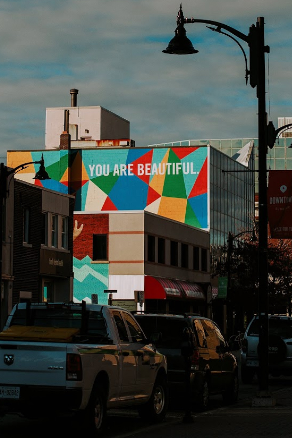 Graffiti on a building that says you are beautiful